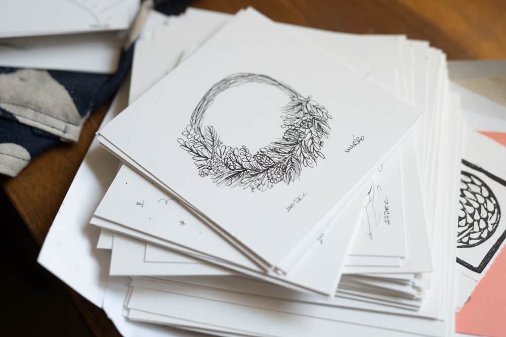 A stack of small drawings and prints on thick paper